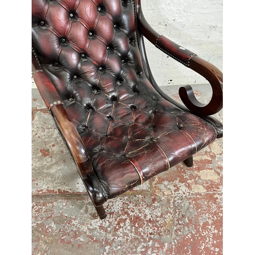 164 - A mahogany and oxblood leather Chesterfield slipper chair