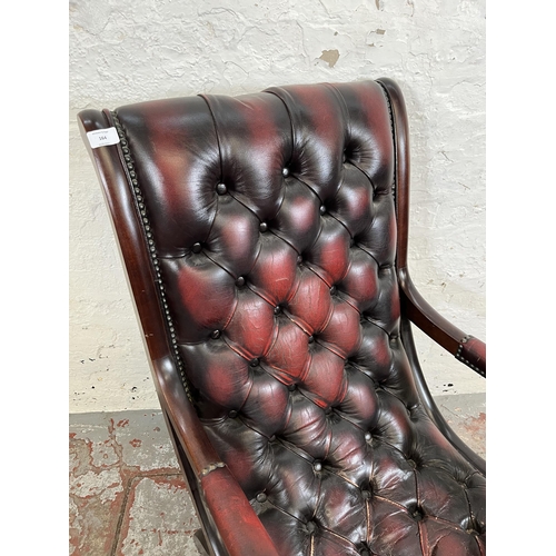 164 - A mahogany and oxblood leather Chesterfield slipper chair