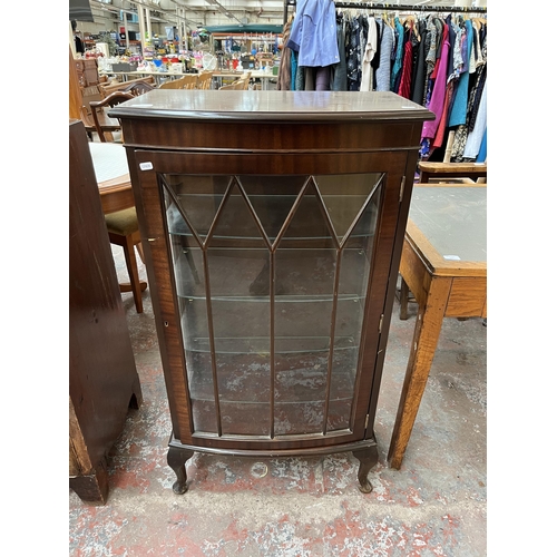 171 - A Georgian style mahogany bow front display cabinet with four glass shelves and cabriole supports