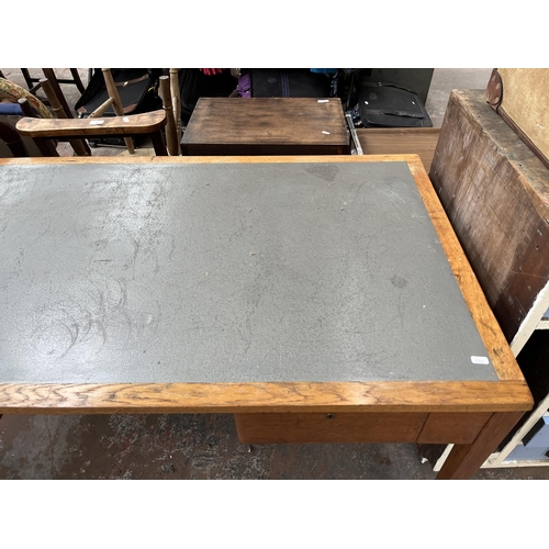 172 - A 1950s oak desk with grey painted writing surface, believed to be designed for the M.O.D.