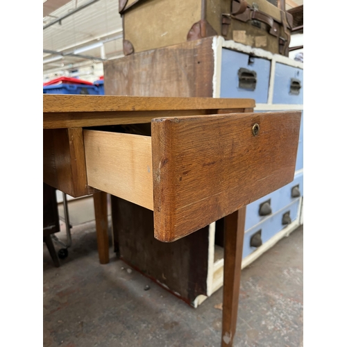 172 - A 1950s oak desk with grey painted writing surface, believed to be designed for the M.O.D.