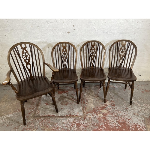 173 - Four beech wheelback dining chairs