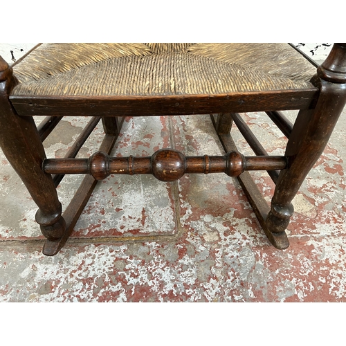 176 - A late 18th century elm and beech spindle back rocking chair with rush seat