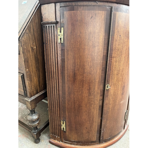 183 - A Georgian oak and mahogany crossbanded bow front wall mountable corner cabinet