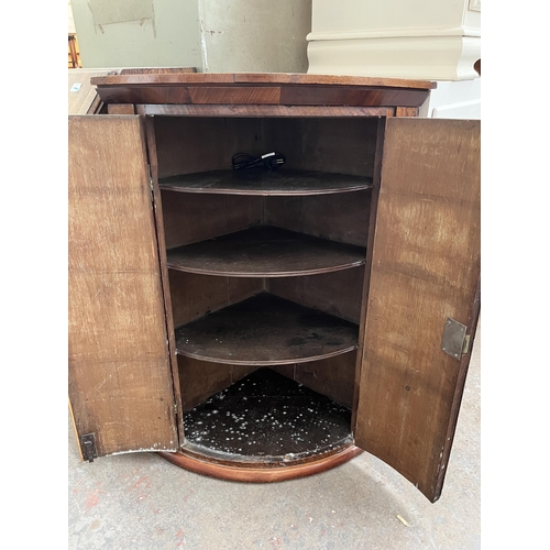 183 - A Georgian oak and mahogany crossbanded bow front wall mountable corner cabinet