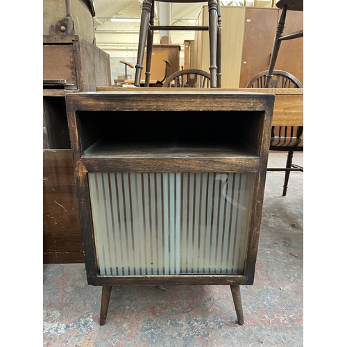 189 - A mid 20th century stained beech and plywood record cabinet with two glass sliding doors