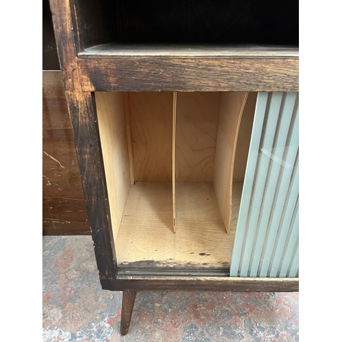 189 - A mid 20th century stained beech and plywood record cabinet with two glass sliding doors