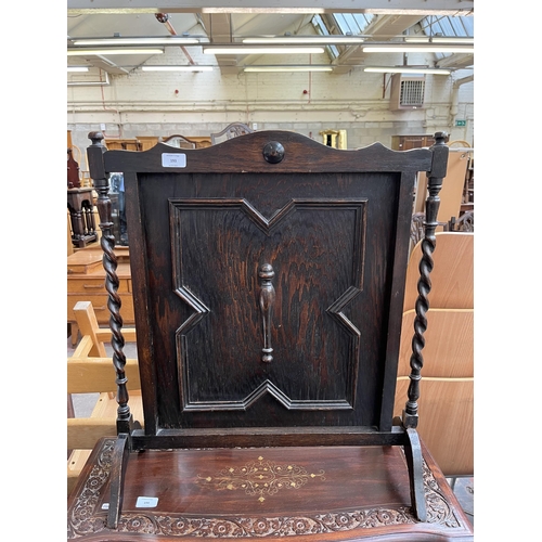 193 - A late 19th/early 20th century geometric carved oak fire screen with barley twist supports