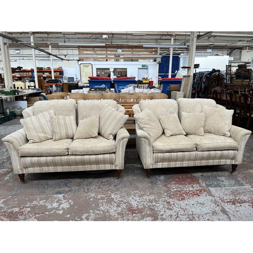 200 - Two Greensmith Stowe fabric upholstered low arm two seater sofas with mahogany supports and brass ca... 