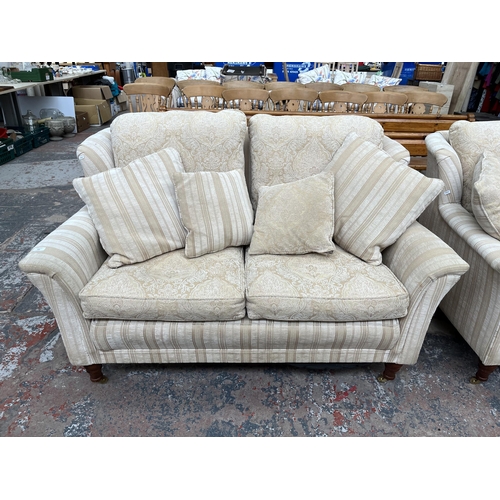 200 - Two Greensmith Stowe fabric upholstered low arm two seater sofas with mahogany supports and brass ca... 