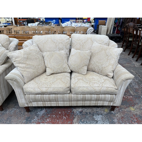 200 - Two Greensmith Stowe fabric upholstered low arm two seater sofas with mahogany supports and brass ca... 