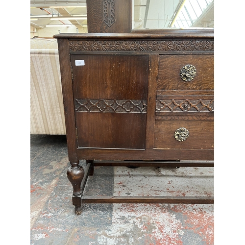 208 - A 1920s/30s carved oak mirror back sideboard with baluster supports and fitted gramophone