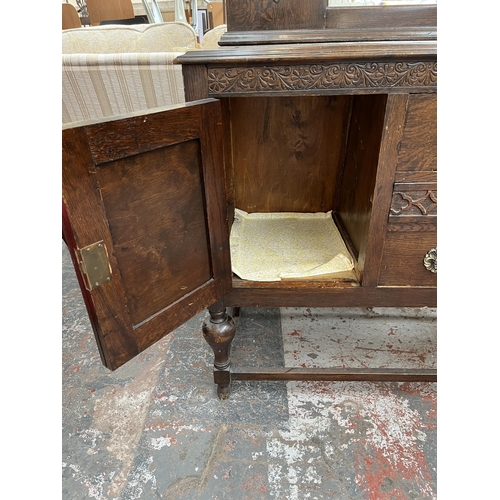 208 - A 1920s/30s carved oak mirror back sideboard with baluster supports and fitted gramophone