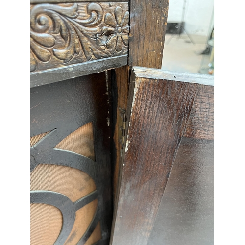 208 - A 1920s/30s carved oak mirror back sideboard with baluster supports and fitted gramophone