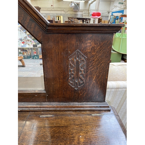 208 - A 1920s/30s carved oak mirror back sideboard with baluster supports and fitted gramophone