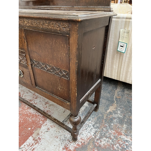 208 - A 1920s/30s carved oak mirror back sideboard with baluster supports and fitted gramophone