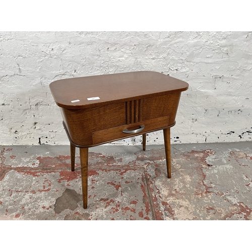 63 - A mid 20th century oak sewing table with splayed supports