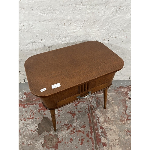 63 - A mid 20th century oak sewing table with splayed supports