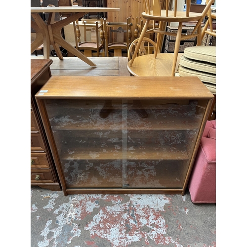 65 - A Turnidge of London Ltd. teak bookcase with two glass sliding doors