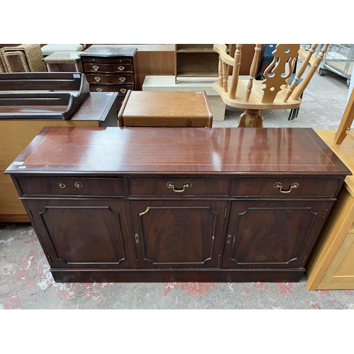 69 - A Georgian style mahogany sideboard with three drawers and three cupboard doors