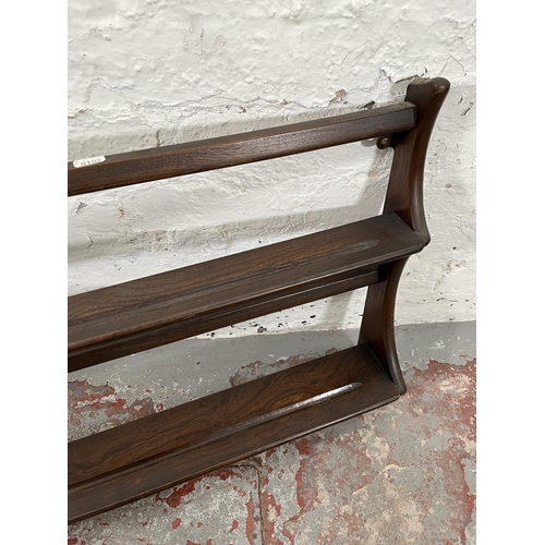 77 - An Ercol elm two tier wall hanging plate rack