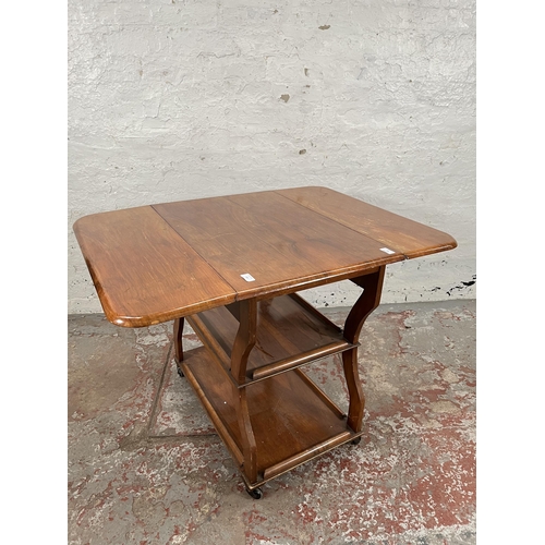 83 - A 1960s Tenax Manchester walnut drop leaf three tier tea trolley