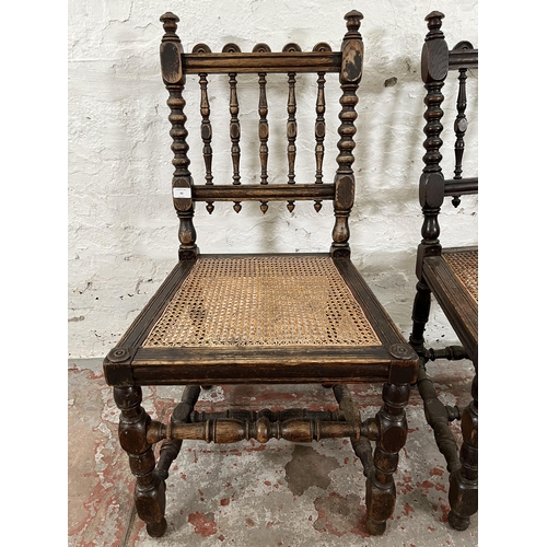 92 - A pair of Victorian carved oak and rattan occasional chairs, both monogrammed 'JHEH' to underside