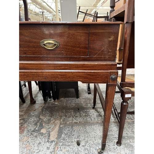 94 - A Regency inlaid mahogany sideboard with two drawers, tapered supports and castors