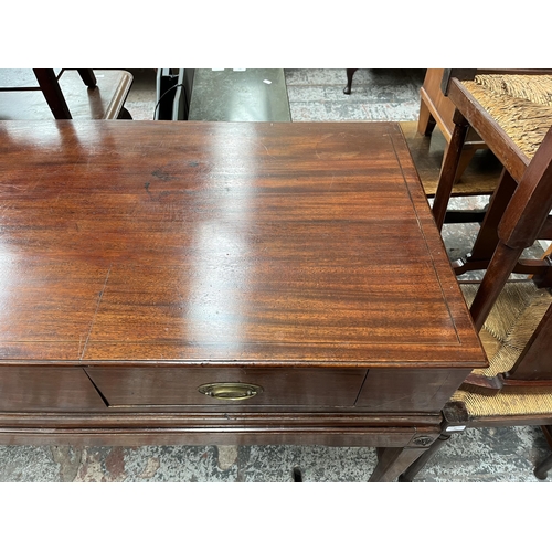 94 - A Regency inlaid mahogany sideboard with two drawers, tapered supports and castors