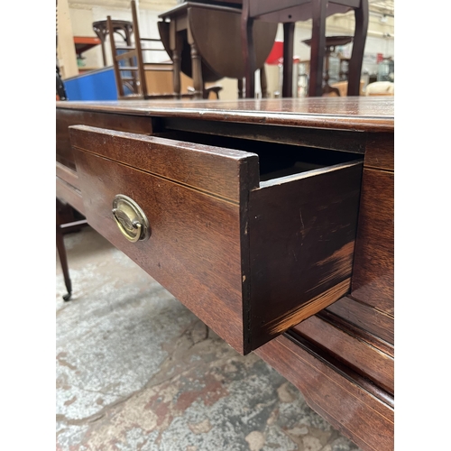 94 - A Regency inlaid mahogany sideboard with two drawers, tapered supports and castors