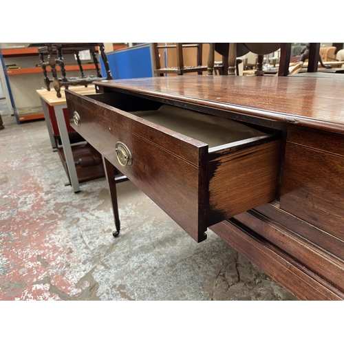 94 - A Regency inlaid mahogany sideboard with two drawers, tapered supports and castors