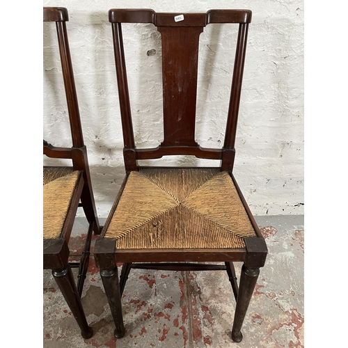 95 - A pair of Edwardian mahogany rush seated occasional chairs