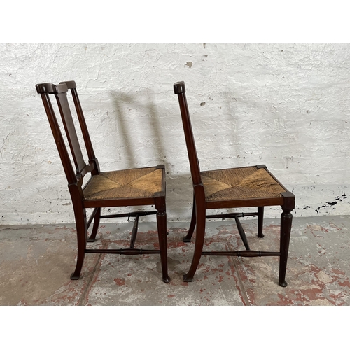 95 - A pair of Edwardian mahogany rush seated occasional chairs