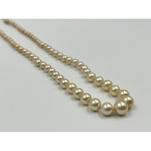 1180 - Two pieces of jewellery, one Ciro pearl necklace with 9ct gold clasp and one pair of .925 silver amb... 