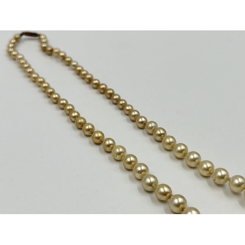 1180 - Two pieces of jewellery, one Ciro pearl necklace with 9ct gold clasp and one pair of .925 silver amb... 