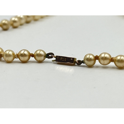 1180 - Two pieces of jewellery, one Ciro pearl necklace with 9ct gold clasp and one pair of .925 silver amb... 