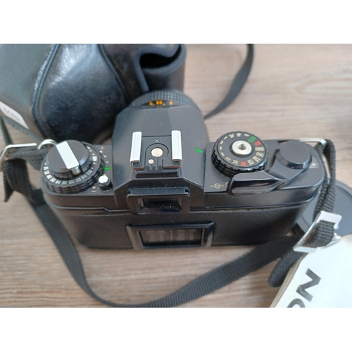 604 - Three 35mm SLR cameras, one cased Chinon CE-4 fitted with 1:1.7 50mm lens with instruction manual an... 