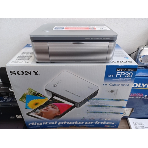 615 - Five cased items, one boxed Panasonic Lumix FS10 12.1mp compact digital camera, one boxed Sony DPP-F... 