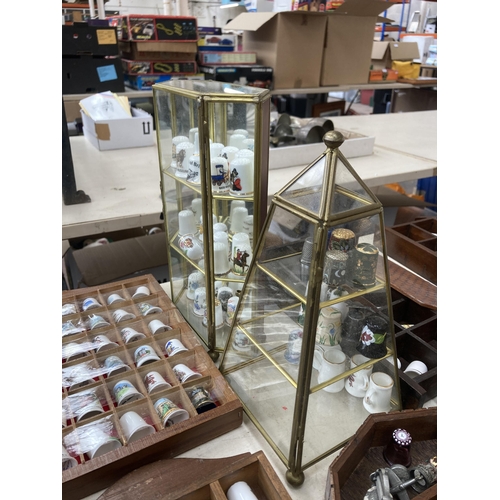 317 - A large collection of thimbles and display racks to include ceramic, hallmarked sterling silver, gla... 