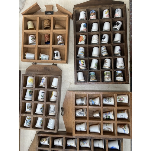 317 - A large collection of thimbles and display racks to include ceramic, hallmarked sterling silver, gla... 