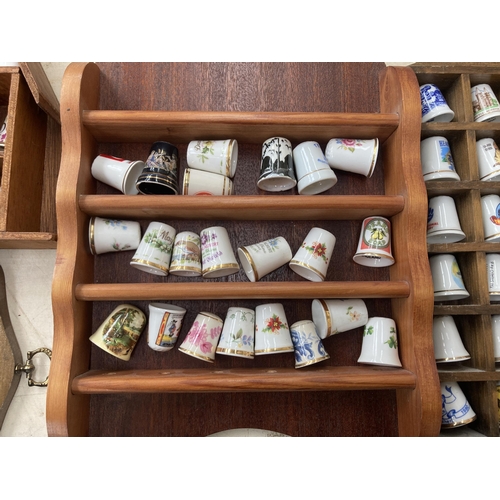 317 - A large collection of thimbles and display racks to include ceramic, hallmarked sterling silver, gla... 