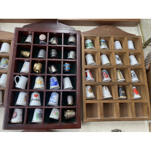 317 - A large collection of thimbles and display racks to include ceramic, hallmarked sterling silver, gla... 