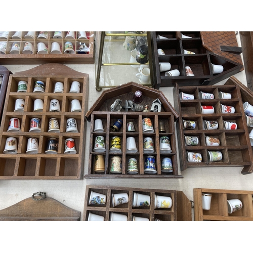 317 - A large collection of thimbles and display racks to include ceramic, hallmarked sterling silver, gla... 