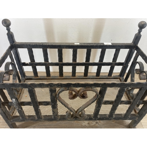 328 - A cast and wrought iron rectangular fire grate/planter with heart design - approx. 48cm high x 66cm ... 