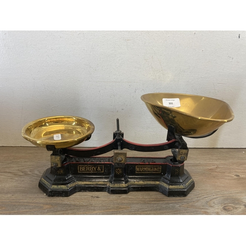 331 - A collection of brassware to include Berry & Warmington Ltd. cast iron weighing scales with brass pa... 