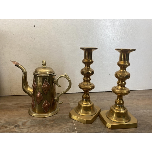 340 - A collection of brassware to include three pairs of candlesticks, two section magazine rack, British... 