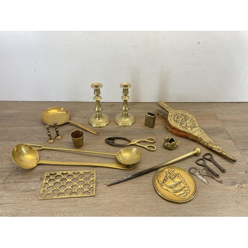 340 - A collection of brassware to include three pairs of candlesticks, two section magazine rack, British... 