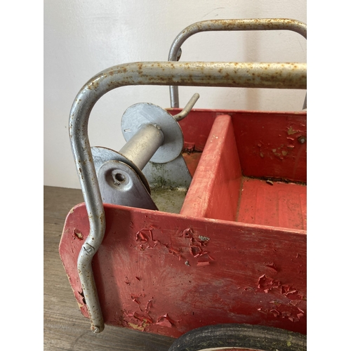 365 - A mid 20th century red painted metal ride on pedal fire truck - approx. 54cm high x 40cm wide x 97cm... 