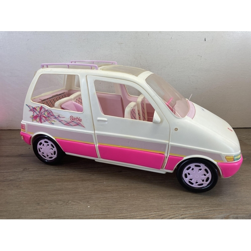 373 - Four Barbie items, one Deluxe dolls trunk and three model vehicles