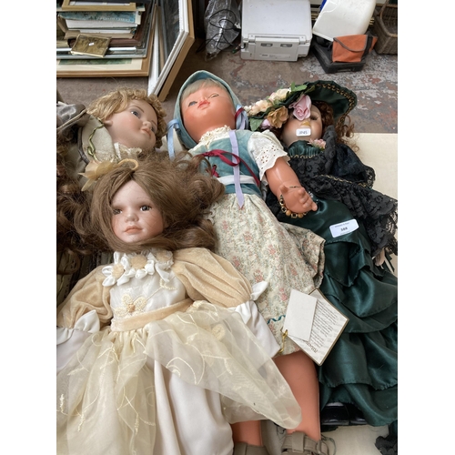 388 - Seven dolls, five porcelain and two plastic